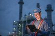 © Kenstocker - Engineering man working with digital tablet on power plant working site at night time.