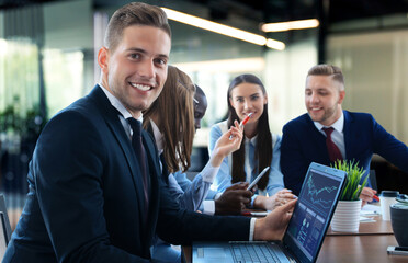 Poster - Businessman with colleagues in the background in office