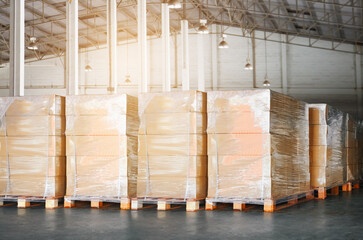 Wall Mural - Package Boxes Wrapped Plastic Stacked on Pallets in Warehouse. Bulk Pallets in Storage Warehouse. Supply Chain, Supplies Shipment. Warehouse Shipping Logistics.	