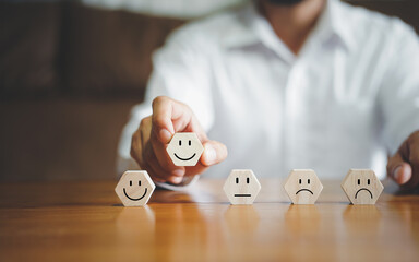 Businessmen choosing on the happy Smile face icon to give satisfaction in service, Customer service and Satisfaction concept, rating very impressed. review, feedback, best quality, good mood.