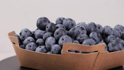 Wall Mural - organic blueberry in box food rotation light background