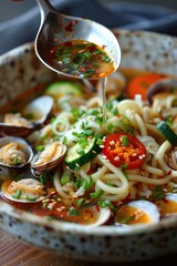 Wall Mural - A bowl of noodle soup with clams and vegetables.