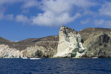 High angle view of two yachts sailing on the sea against white rock and cliff, Santorini, Greece
