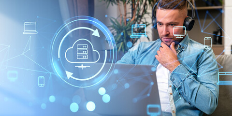 Poster - Man in headphones using laptop, cloud service hologram and system backup