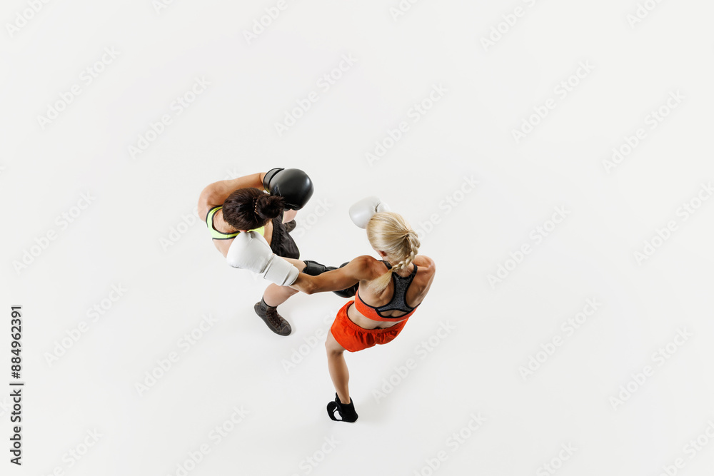 Top view of two competitive and focused women, boxing athletes in ...