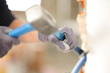 © Antonioguillem - Construction worker using a escarpment and hammer to wrek a wall