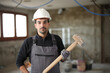 © Antonioguillem - Serious construction worker posing with hammer