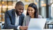 © thesweetsheep - Pair of Diverse Businesspeople Happy Working on Laptop Together in Office Setting