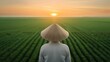 © JP STUDIO LAB - Back view of a woman in a conical hat in a green field, looking at the sunrise, calm countryside, high-resolution shot, focus cover all object