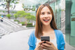 © sitthiphong - woman using smartphone in public areas, During leisure time. The concept of using the phone is essential in everyday life.