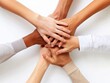 © Aimage - photo from above, various hands stacked together, showing teamwork, unity, and collaboration on a white background.concept of unity and mutual cooperation care