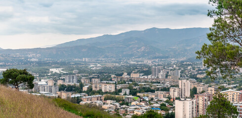 Wall Mural - View of the Georgian city of Tbilisi from the side of the sculptural composition Chronicle of Georgia. Aerial view of houses and mountains in Tbilisi, Georgia.