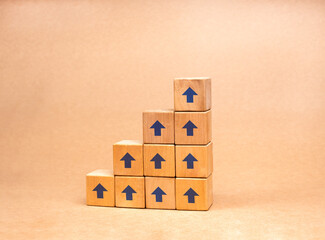 Poster - Profit, benefit, income, business growth process, trend, economic improvement concepts. Blue up arrow on wooden cube blocks build as bar graph steps, diagram chart on brown recycled paper background.