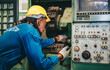 © SpaceOak - Factory Maintenance Worker uses Flashlight to Inspect and Perform Maintenance on Industrial Machine