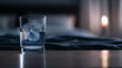 © May Chanikran - A glass of water on a bedside table in a dimly lit bedroom, with blurred background creating a cozy and peaceful atmosphere.