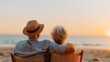 © Pinklife - An older couple with light summer hats sits cozily on beach chairs, enjoying the calmness of the beach sunset, their backs towards the camera under the warm sunset sky.