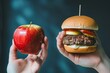 © Maryam - One hand holding apple fruit, other holding hamburger. Healthy natural organic fresh vegetarian food vs unhealthy processed fast junk food meat. Nutrition diet lifestyle, fitness eating choice