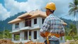 © Anurak - Construction Worker Standing in Front of New Home.