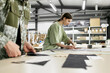 © Westend61 - Young fashion designer working with colleague at workshop