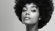 © Nataliia_Trushchenko - A woman with a short afro is standing in front of a white background. Beauty Fashion model. Black woman face beautiful voluminous hair. Afro american girl. Beauty skin female face.