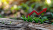 © Creative mind - Concept of sustainable growth and green economy rise with red upward arrow and young foliage. Red growth indicator on wood.