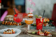 © Nander - Close-up shot of three cocktails on a restaurant table filled with delicious food