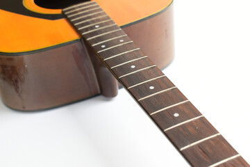 brown wood acoustic guitar isolated on white background