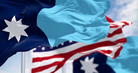 Close-up of Minnesota new state flag waving with the american flag on a clear day