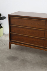 Classic mid-century modern dresser. Vintage wooden bedroom furniture. Close-up photograph.