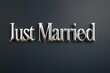 © Jullia - Elegant Silver 'Just Married' Sign on Sophisticated Dark Background for Wedding Celebrations