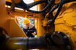 © Parilov - Machinery tractor mechanic checks hydraulic hose system equipment on excavator. Concept industry truck maintenance