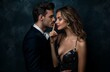 © panumas - A couple in elegant attire, with the woman holding her finger to the man's lips.