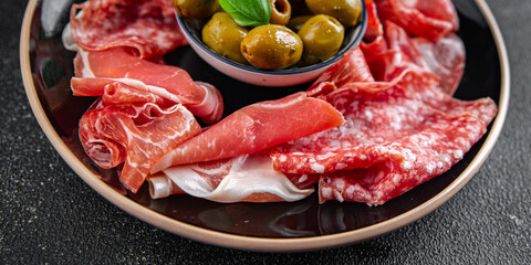 Wall Mural - meat plate different types of meat salami, prosciutto, sausage, coppa natural food fresh appetizer meal food snack on the table copy space food background rustic top view