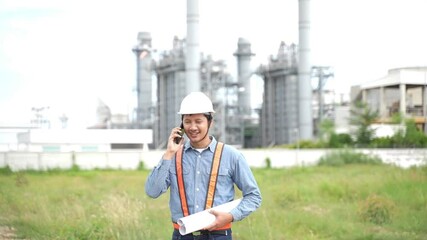 Wall Mural - Project engineering talking telephone and holding drawing plan and check Construction Site at Industrial Power Plant.