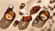 © Jayleen - chaotic arrangement of amber glass jar mockups with moisturizer on beige background cosmetic containers create sharp shadows in flat lay composition