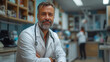 © Octavio - Senior male doctor with a beard in a clinic, representing trust and professionalism in healthcare.