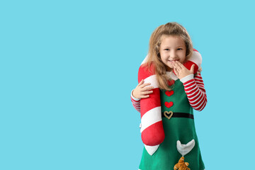 Poster - Cute little girl with beautiful Christmas cushion on color background