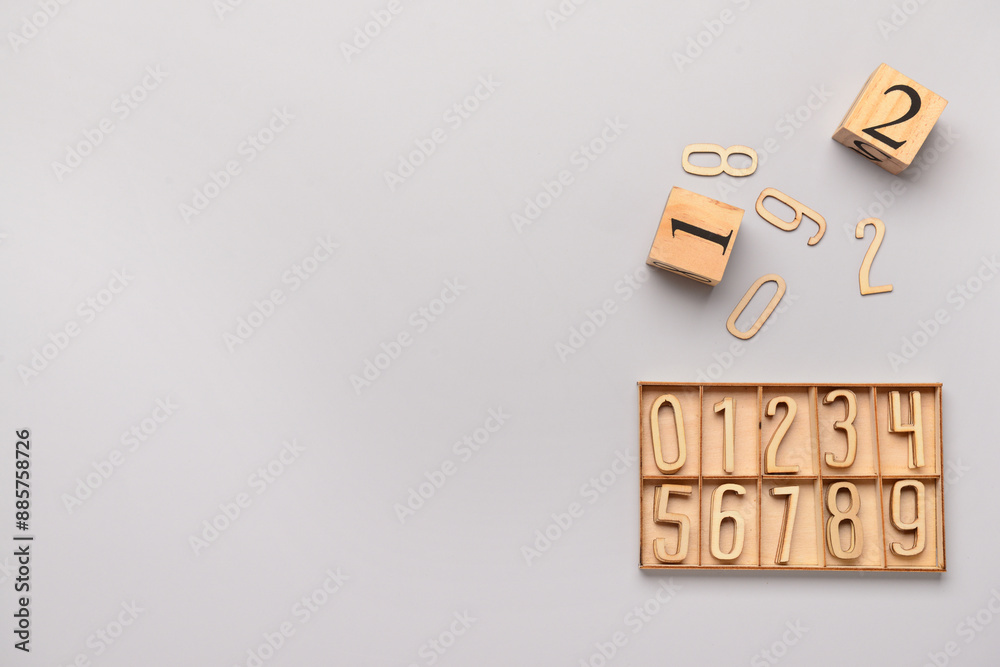 Wooden box with numbers on grey background. Top view