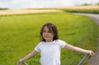 © PeterPike - A little schoolgirl girl in glasses against the backdrop of a field of ripe wheat. Children's travel concept