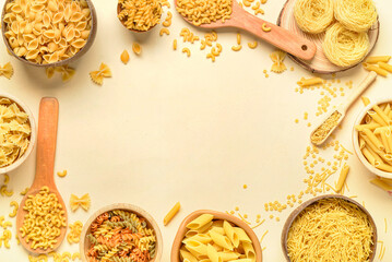 Wall Mural - Frame made of different uncooked pasta on light background