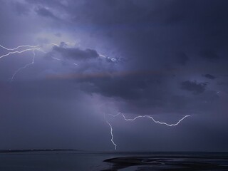 Intense lightning bolts and thunderstorm over North Atlantic ocean.