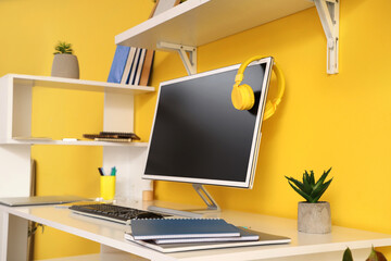 Sticker - Computer monitor with headphones on table in teenager's room