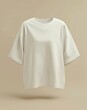 © umut hasanoglu - Minimalist beige oversized t-shirt on a simple beige background, showcasing minimalistic fashion style.