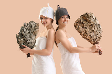 Sticker - Young women in sauna hats with whisks on beige background