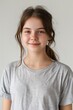 © Alena - A close-up shot of a young girl with long brown hair wearing a gray t-shirt, suitable for editorial or commercial use