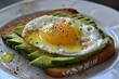 © ylivdesign - Nutritious avocado toast topped with a perfectly cooked sunny side up egg, sprinkled with pepper