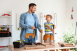 © Pixel-Shot - Happy father and his little son with different instruments assembling furniture at home