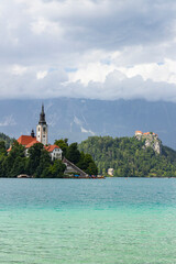 Wall Mural - Panoramic view from Lake Bled, beauty heritage in Slovenia. Island with church and castle in the background create a dream setting. View from Ojstrica and Mala Osojnica with the heart-shaped bench.