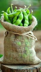 Sticker - Fresh Green Soybeans in a Burlap Sack on Rustic Wooden Background, Close Up, Selective Focus.