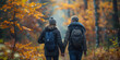 © khonkangrua - Elderly couple holding hands while hiking through a colorful autumn forest, enjoying the peaceful and scenic environment.